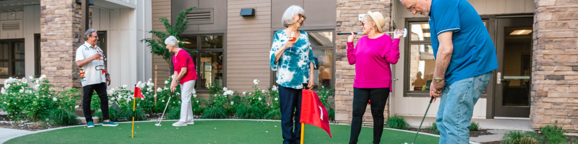Older adults playing golf