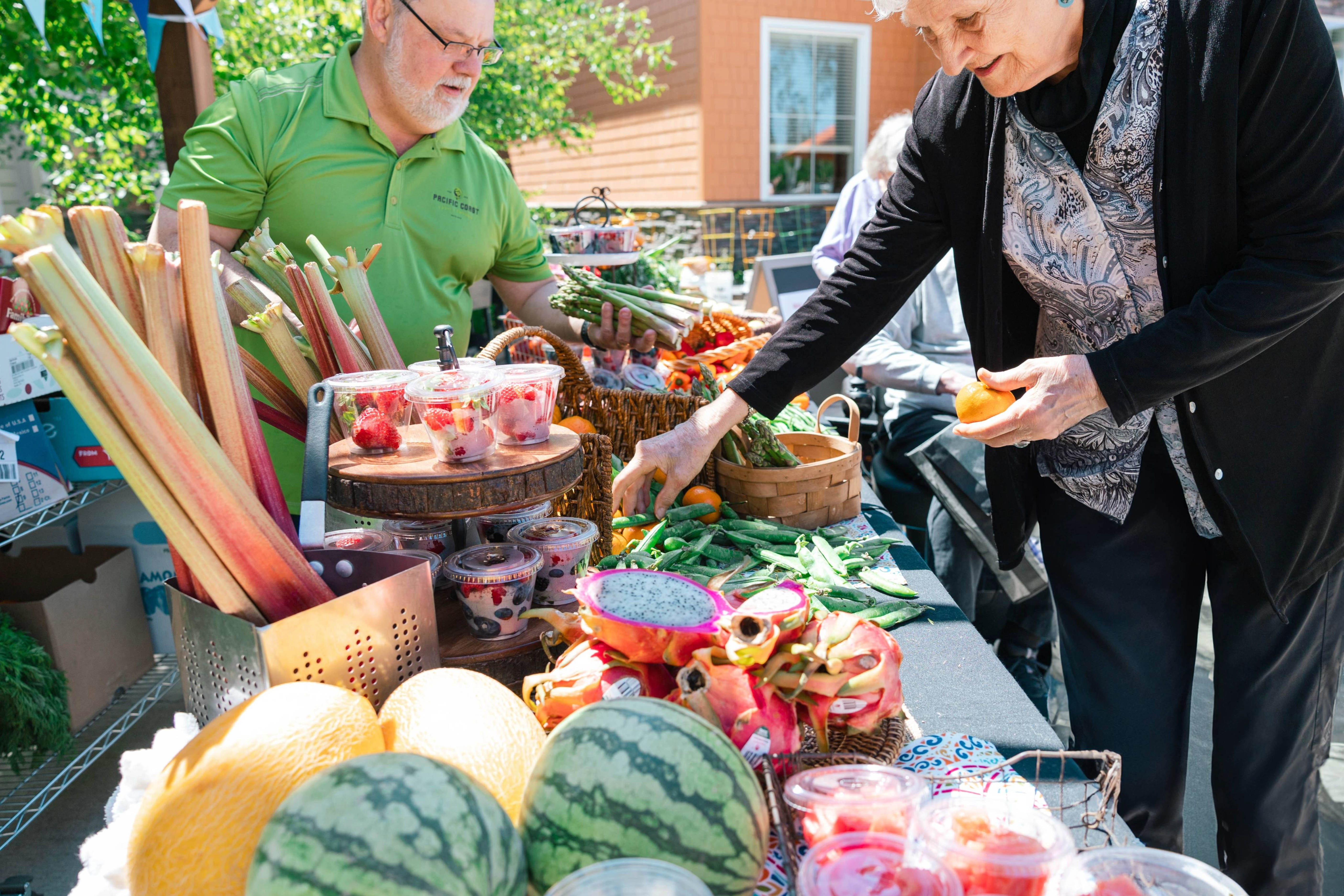 Older woman and a man at a farmers market