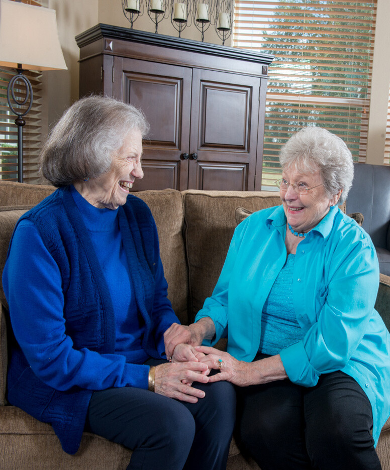 Two women sitting in a common area