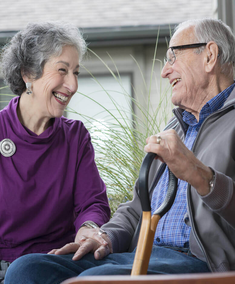 Couple setting on a bench and laughing together