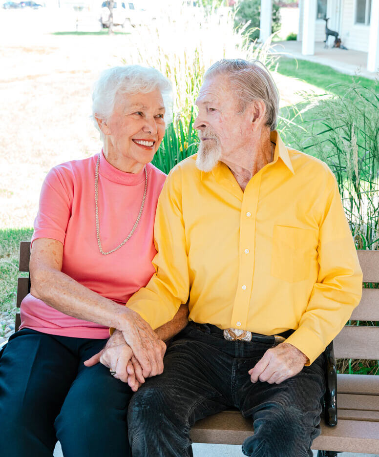 Resident couple sitting outside at Mill Creek community