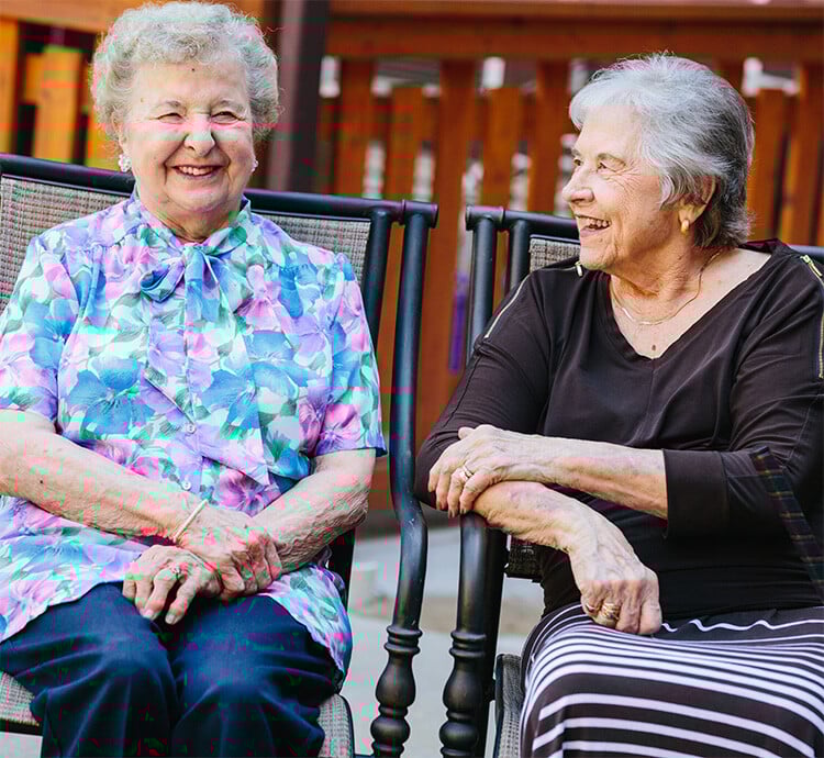 Two older women laughing together