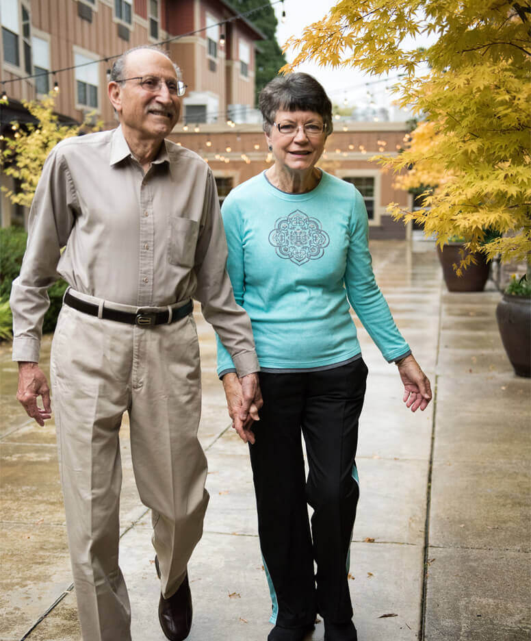Couple walking outside the Clackamas Woods community