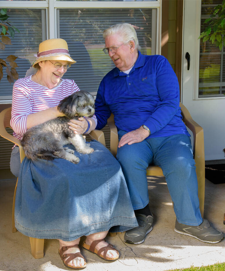 Resident couple with a dog at the Willowcreek community