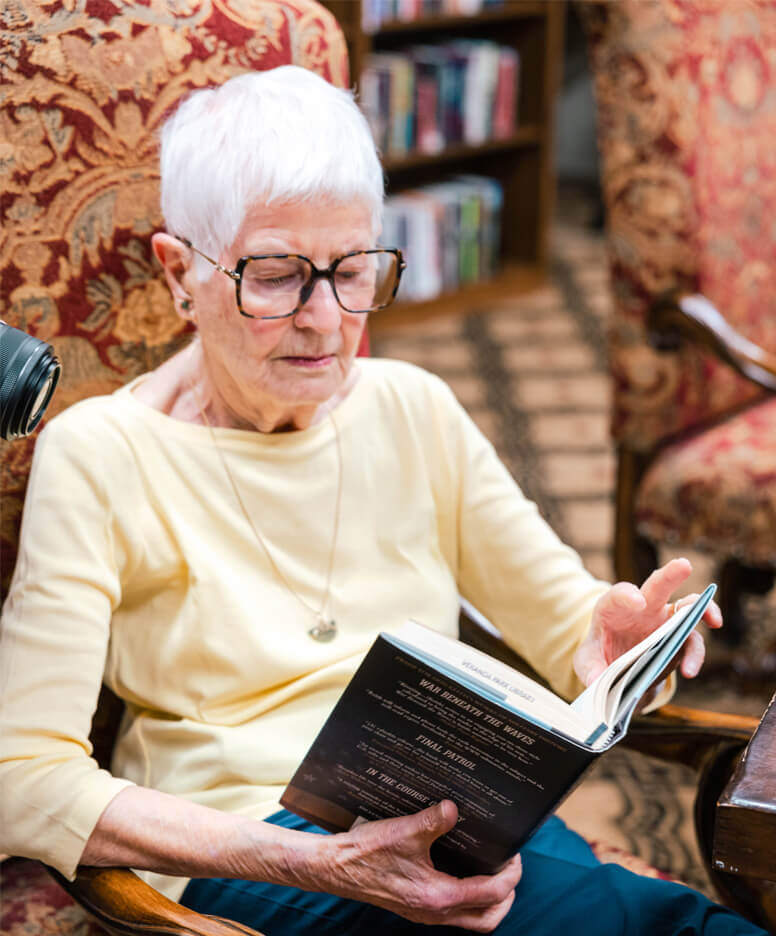 Resident reading a book at the Veranda Park community