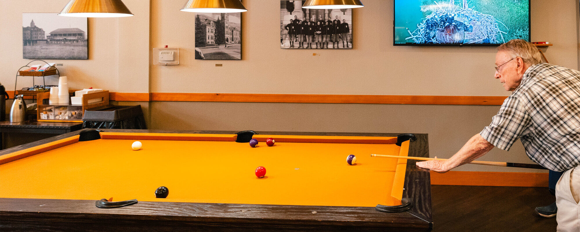 Resident playing pool at the Missoula community