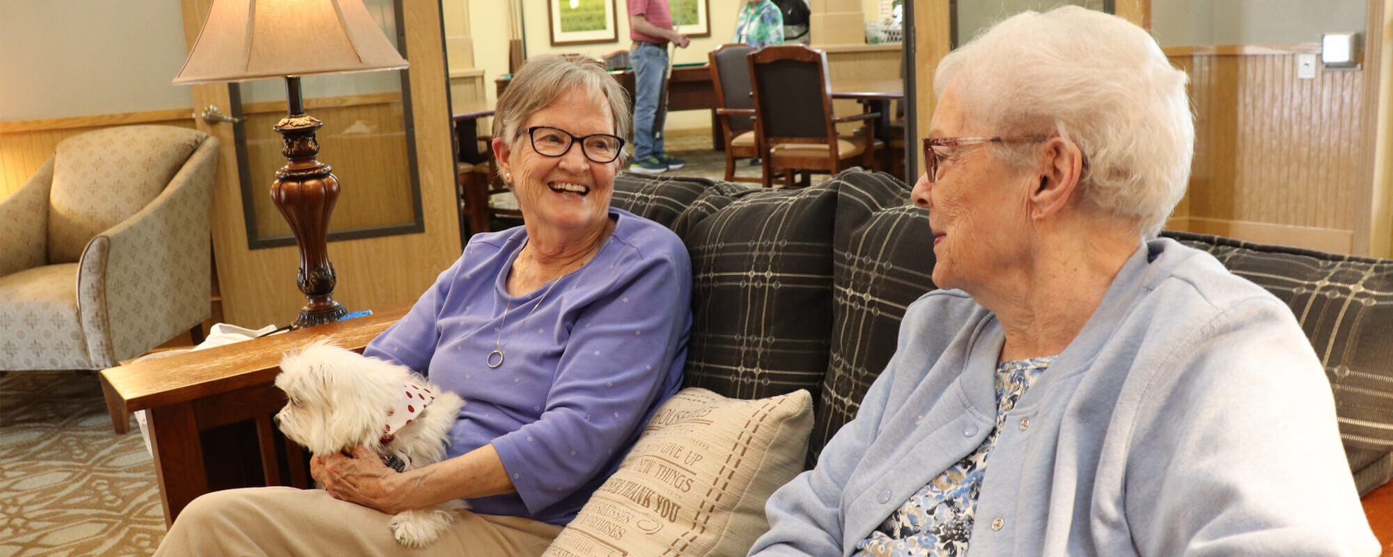 Two residents sitting in the common area at the Sunnyview community