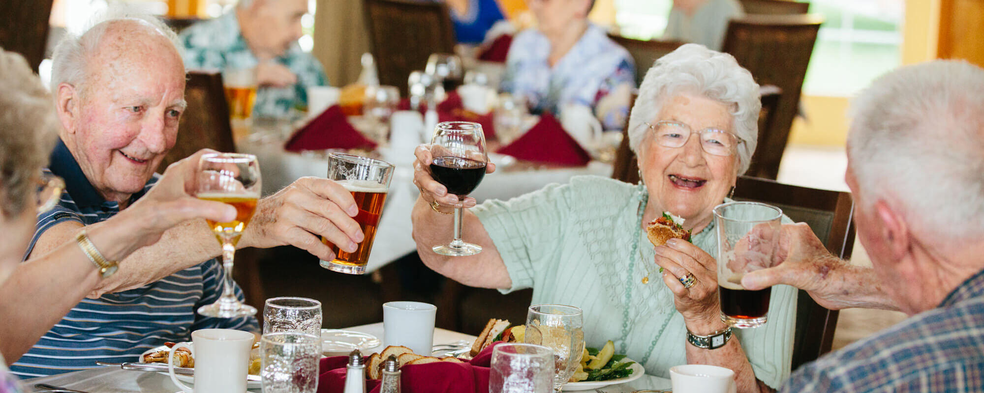 Residents toasting in the dining room at the Lancaster Village community