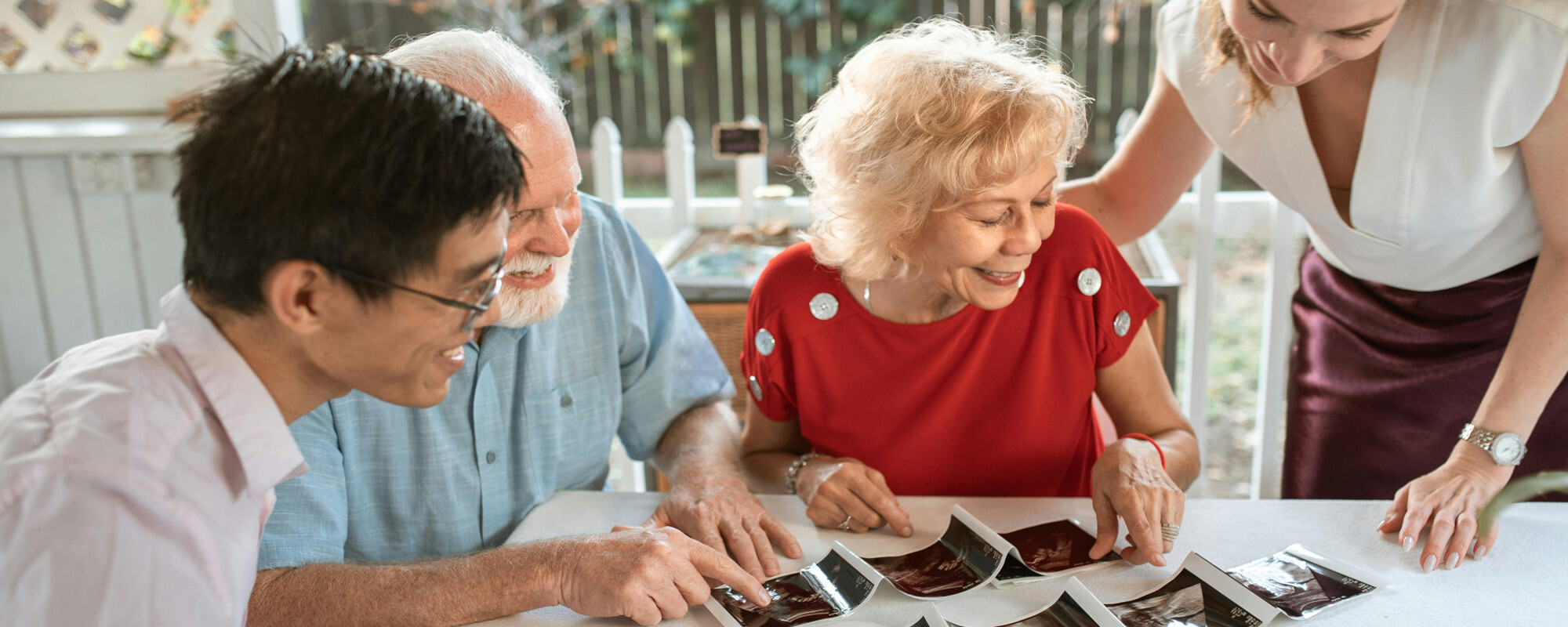 Family looking at pictures at a table