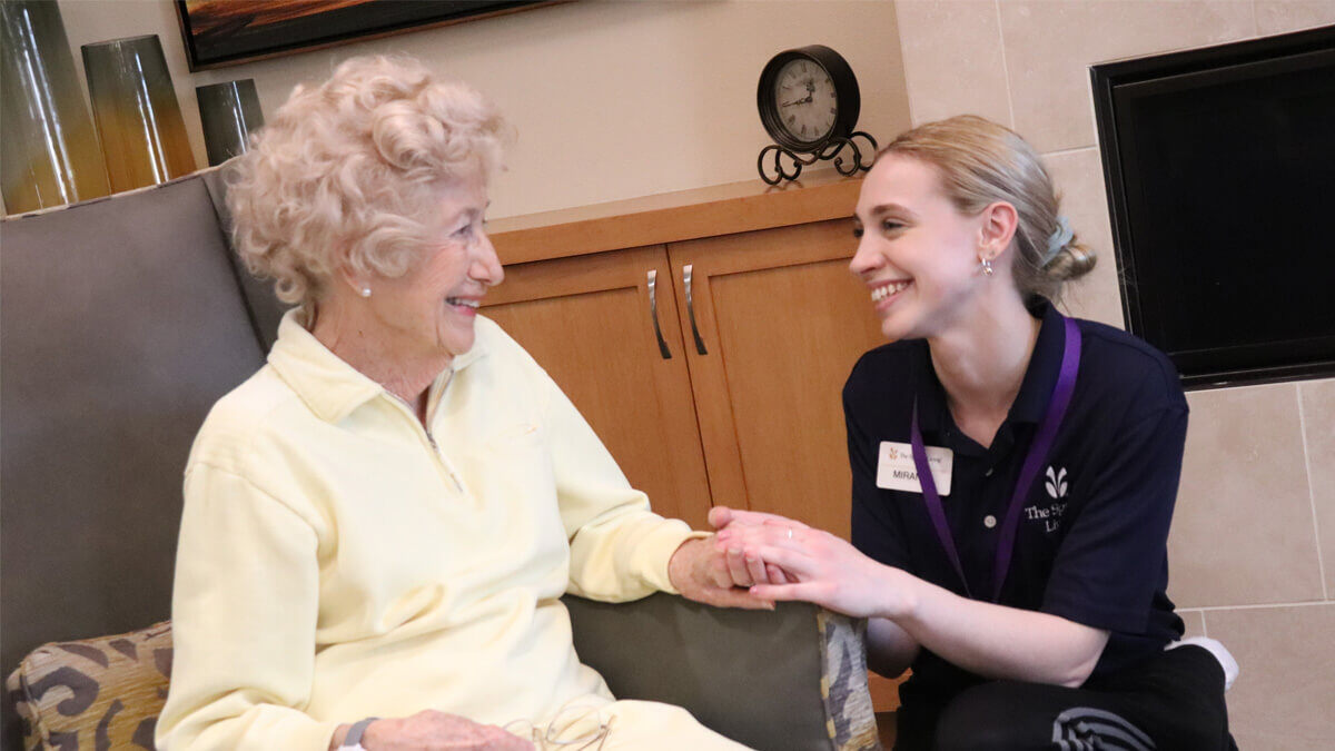 Care giver and resident talking at the Lancaster Village community