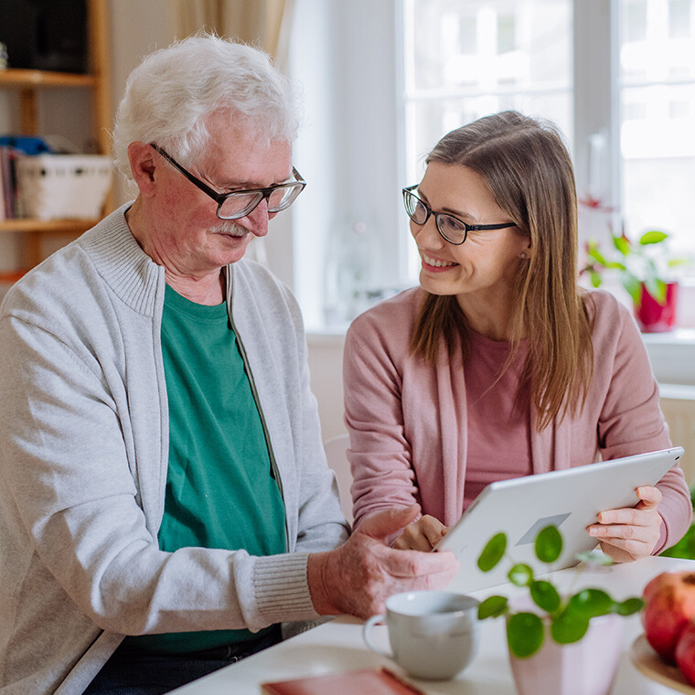 Adult daughter visiting senior father