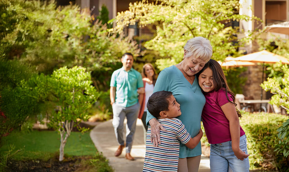 Woman hugging her grandchildren