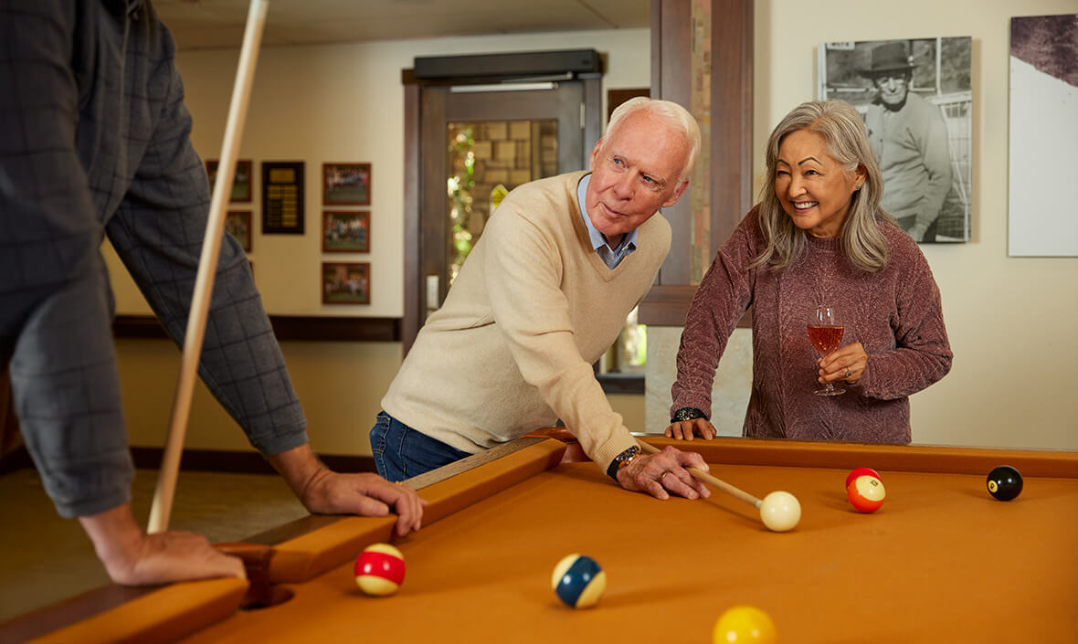 Man and woman playing pool together