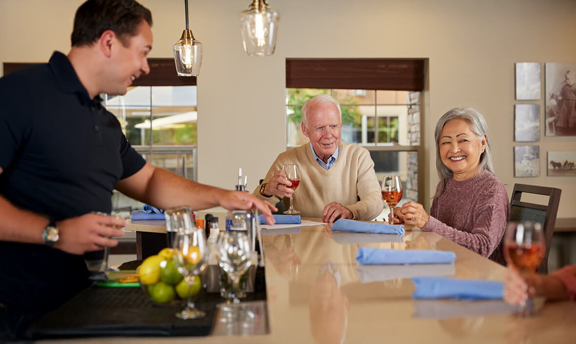 Bartender giving a man and a woman their drinks