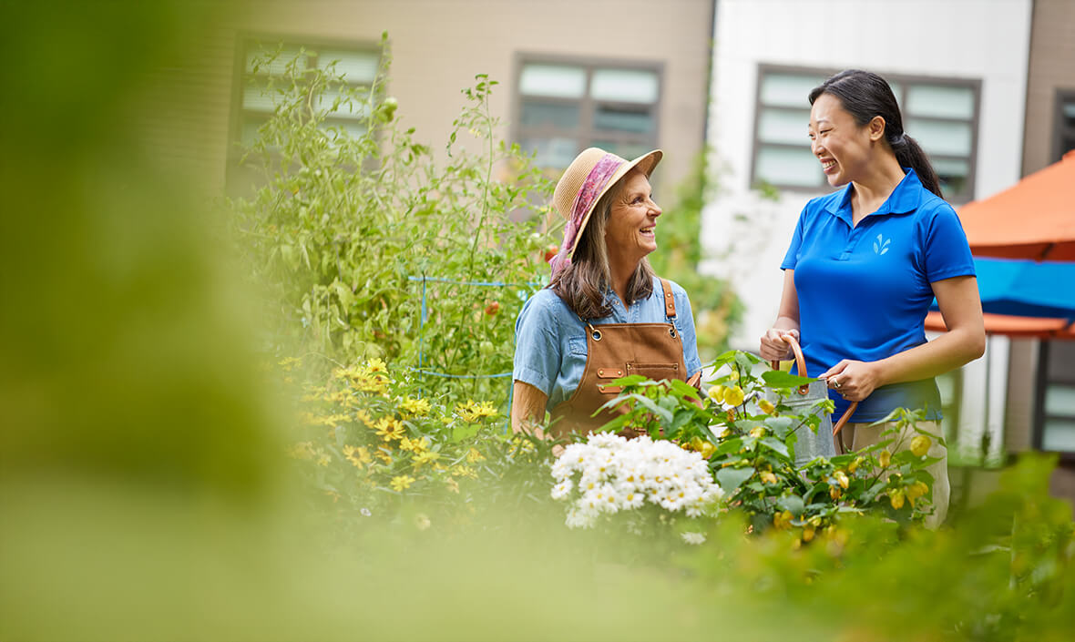 Two women talking in a flower garden