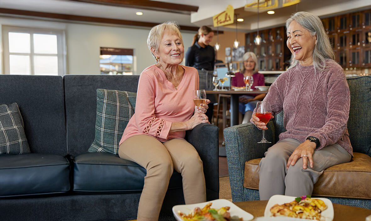 Two women sitting and drinking wine together