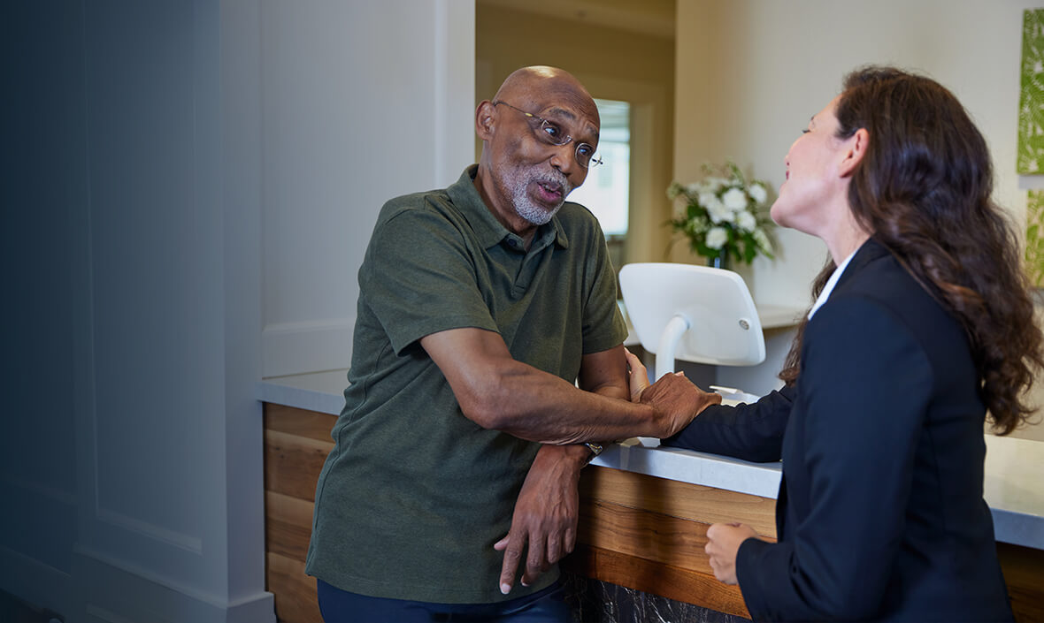 Woman talking to a man at a counter