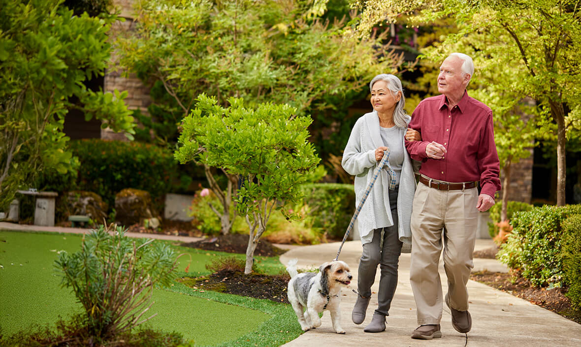 Man and woman going for a walk with their dog