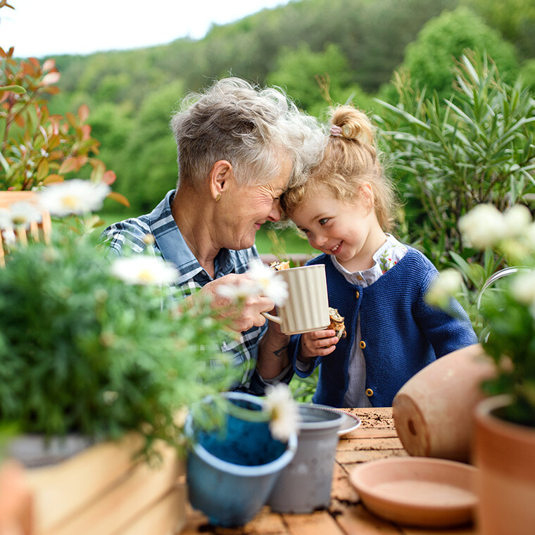 Senior grandmother gardening with grandchild