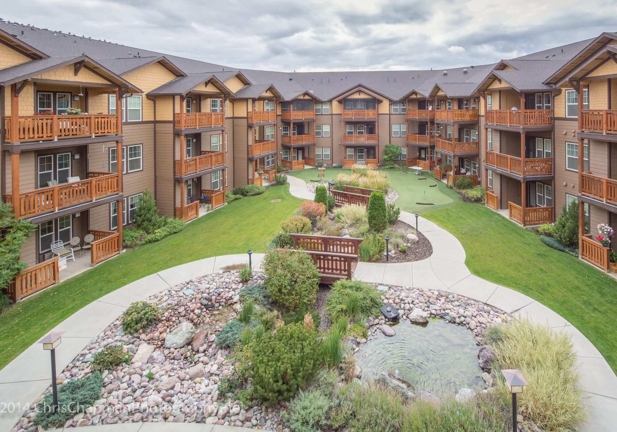 The Springs at Missoula's beautiful courtyard with greenery and water features.