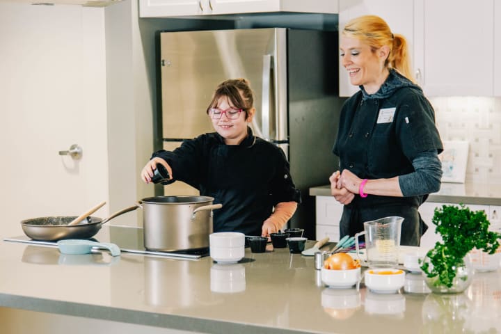Chef Jamie of The Springs Living at Sherwood, Oregon and her daughter Meadow make their family favorite Clam Chowder for senior living residents who are retired at the Springs Living Assisted Living in Sherwood, OR