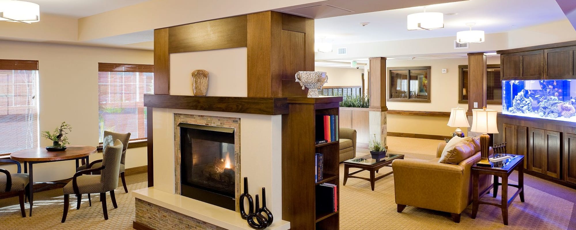 Comfortable lounge area with fireplace and aquarium at The Springs at Tanasbourne in Hillsboro, Oregon
