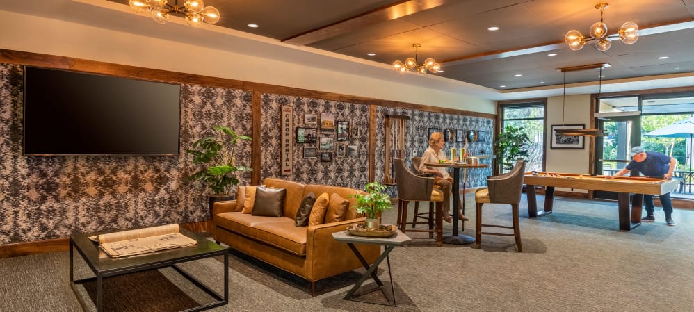 Activity lounge with games, a bar, and tv's at The Springs at The Waterfront in Vancouver, Washington