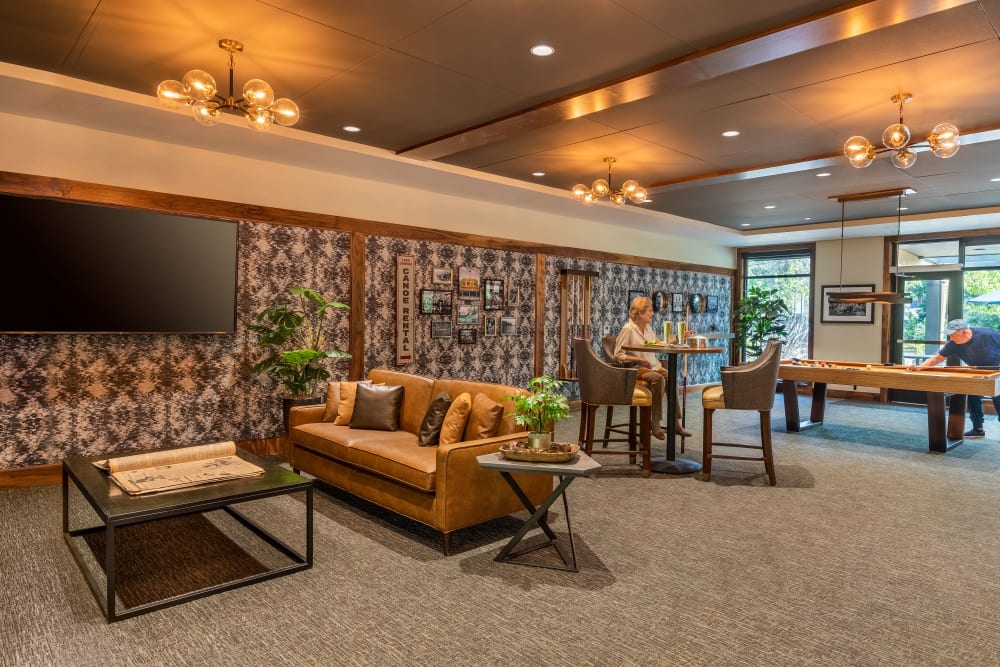 Lounge area with seating, a pool table, tv's and a bar at The Springs at Lake Oswego in Lake Oswego, Oregon