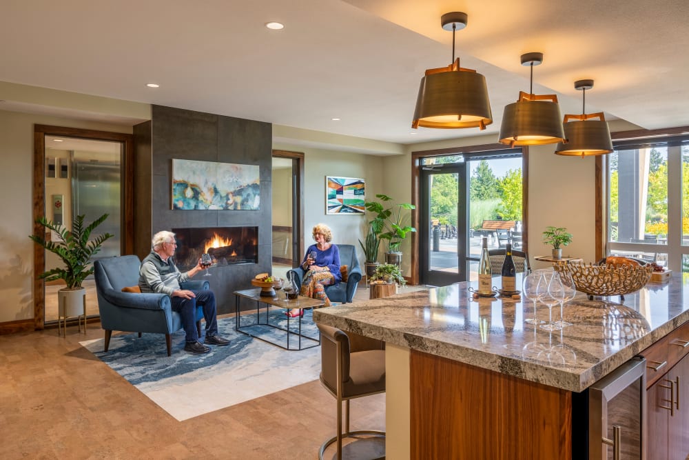 Resident in their apartment drinking wine at The Springs at Lake Oswego in Lake Oswego, Oregon