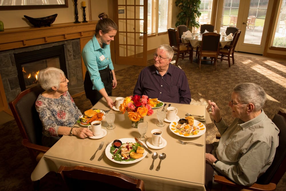 Residents being served in dining room at The Springs at Clackamas Woods in Milwaukie, Oregon.