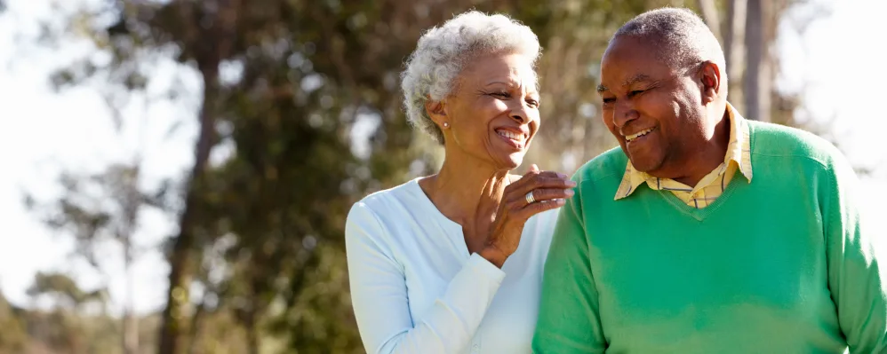 Resident couple walking outside together at The Springs at The Waterfront in Vancouver, Washington