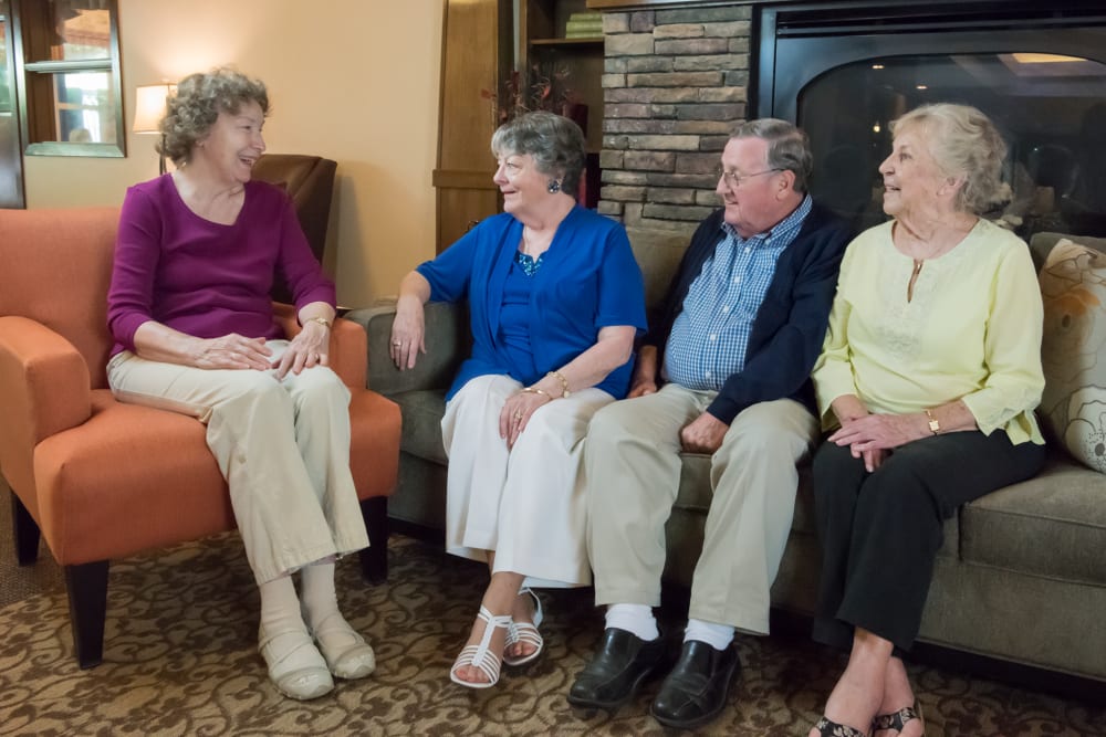 Residents sitting by fireplace in lounge at The Springs at Wilsonville in Wilsonville, Oregon