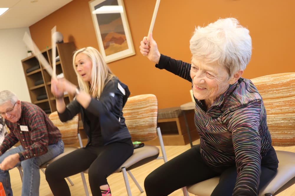 Resident and caregiver doing drumming exercise at The Springs at Bozeman in Bozeman, Montana