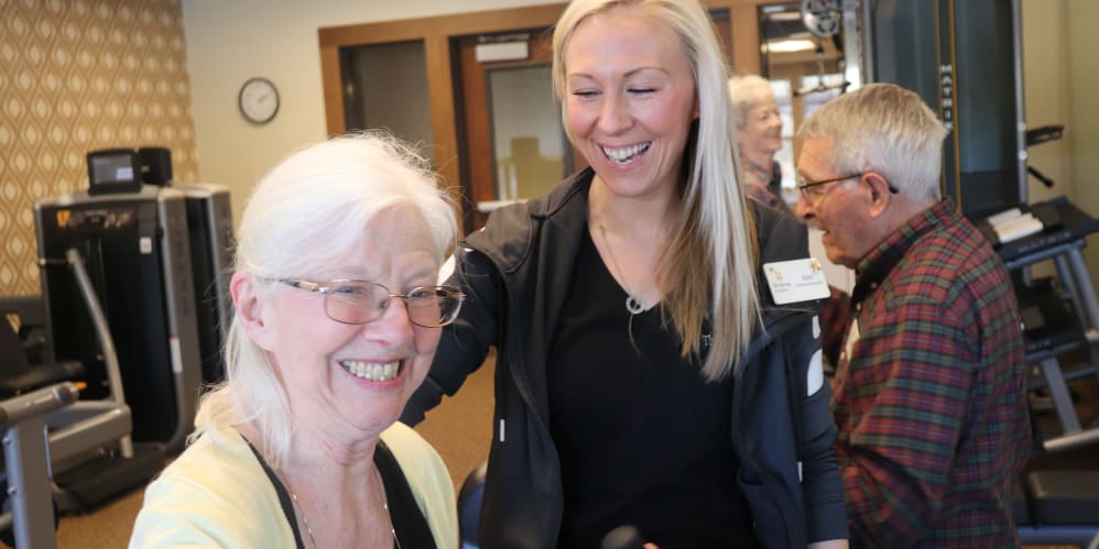 Resident smiling with care giver at The Springs at Bozeman in Bozeman, Montana