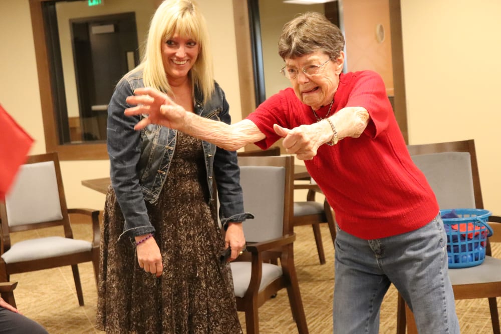 Resident and caregiver playing a game at The Springs at Bozeman in Bozeman, Montanag
