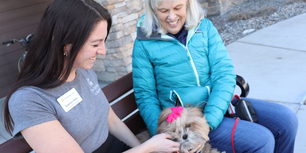 Residents with her dog and caregiver at The Springs at Bozeman in Bozeman, Montana