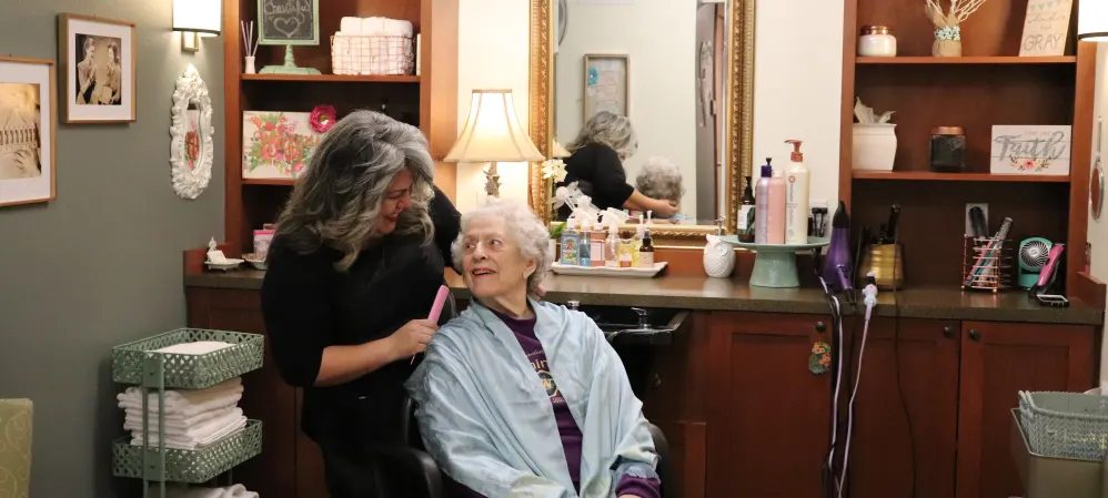Resident getting her hair done at The Springs at Carman Oaks in Lake Oswego, Oregon