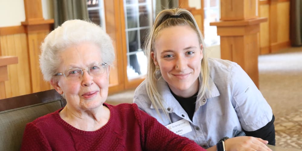 Resident enjoying coffee with caregiver at The Springs at Missoula in Missoula, Montana
