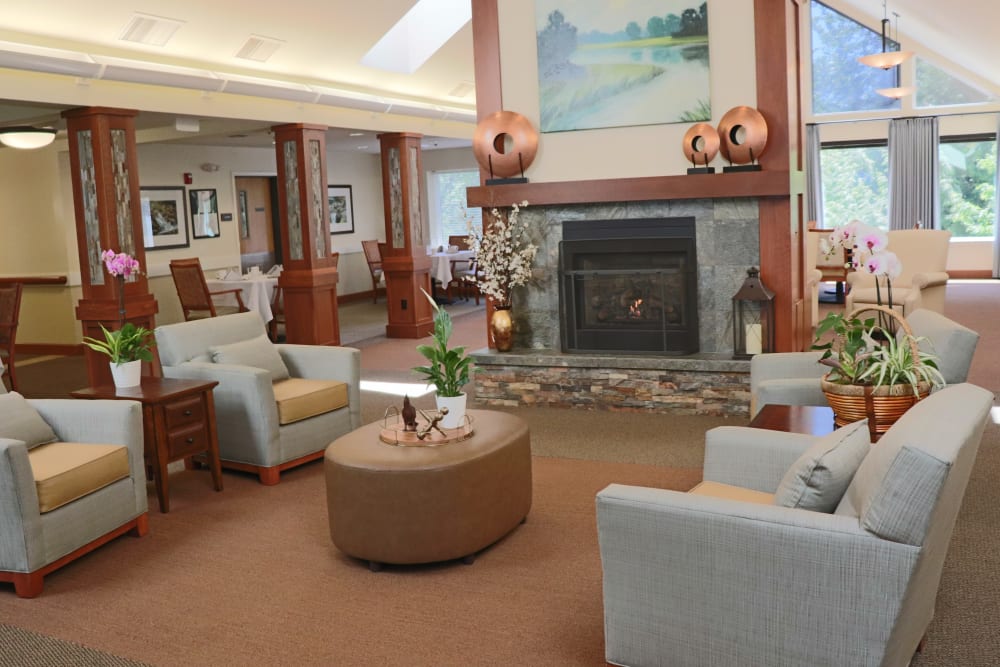 Comfortable community lounge area with fire place at The Springs at Carman Oaks in Lake Oswego, Oregon
