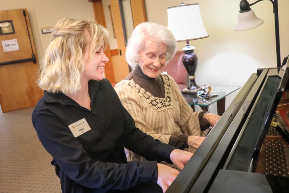 Resident and caregiver playing the piano at The Springs at Mill Creek in The Dalles, Oregon