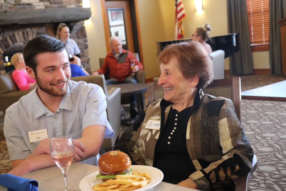 Resident enjoying meal with caregiver at The Springs at Missoula in Missoula, Montana.