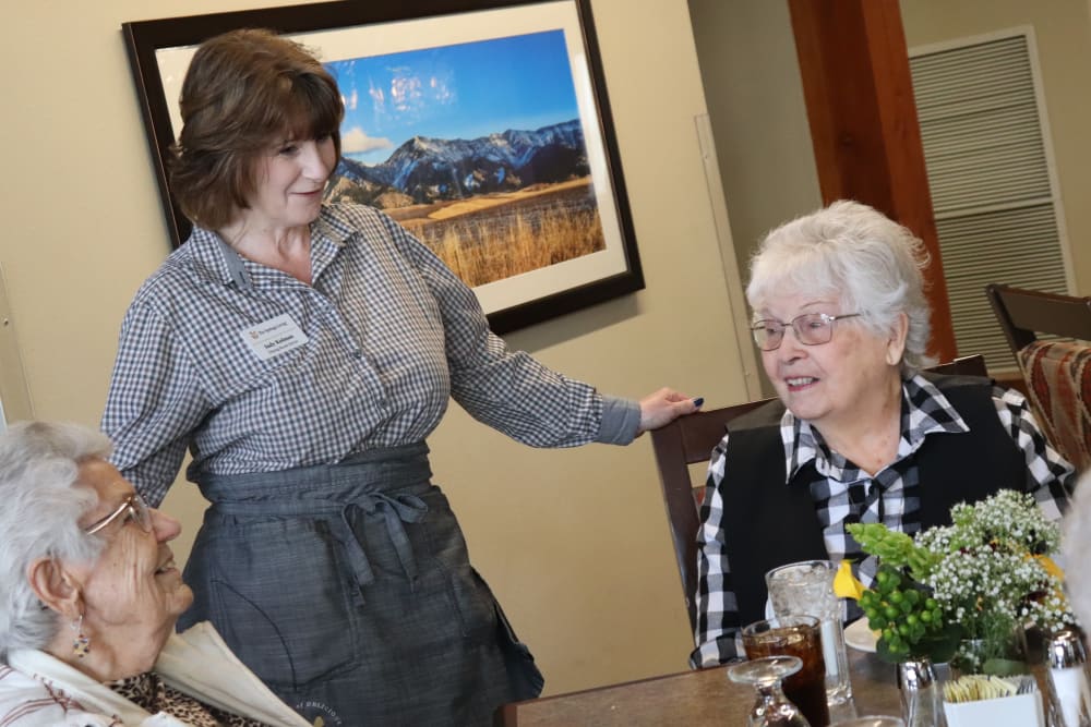 Two residents and a caregiver about to enjoy a meal at The Springs at Butte in Butte, Montana