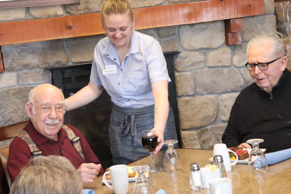 Two residents enjoying a meal with a dedicated caregiver at The Springs at Butte in Butte, Montana