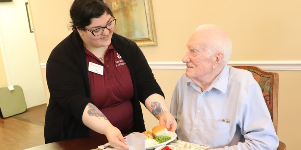 Resident  being served by caregiver at The Springs at Willowcreek in Salem, Oregon