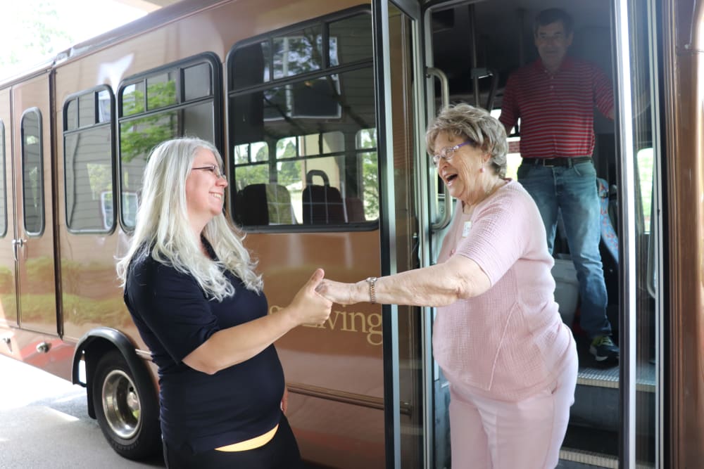 Resident being helped off the community transport bus at The Springs at Sunnyview in Salem, Oregon