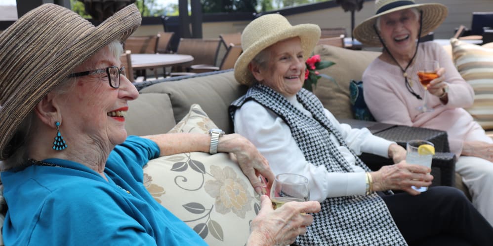Residents enjoying drinks on the patio at The Springs at Carman Oaks in Lake Oswego, Oregon