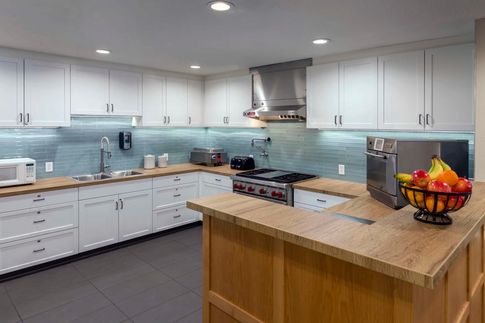 Clean, stylish kitchen with wooden countertops at The Springs at Clackamas Woods in Milwaukie, Oregon