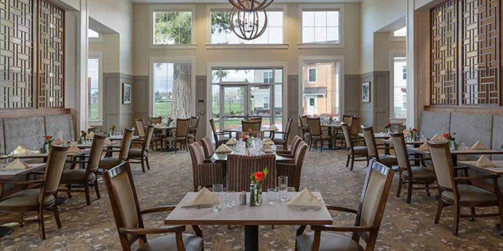 Resident dining room with beautiful modern chandelier at The Springs at Sherwood in Sherwood, Oregon