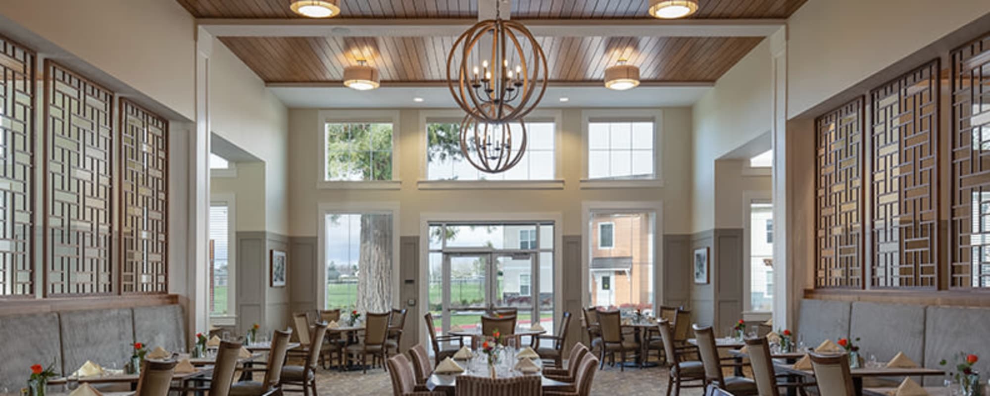 Beautifully well light and elegant common dinning area with modern chandeliers at upscale senior living facility at The Springs at Sherwood in Sherwood, Oregon