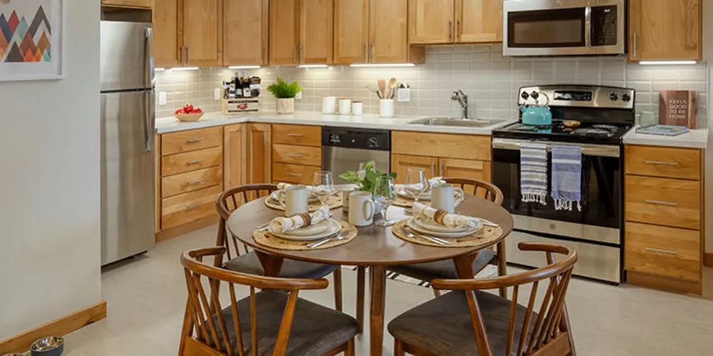 Charming kitchen in senior apartment with wood detailing at The Springs at Sherwood in Sherwood, Oregon